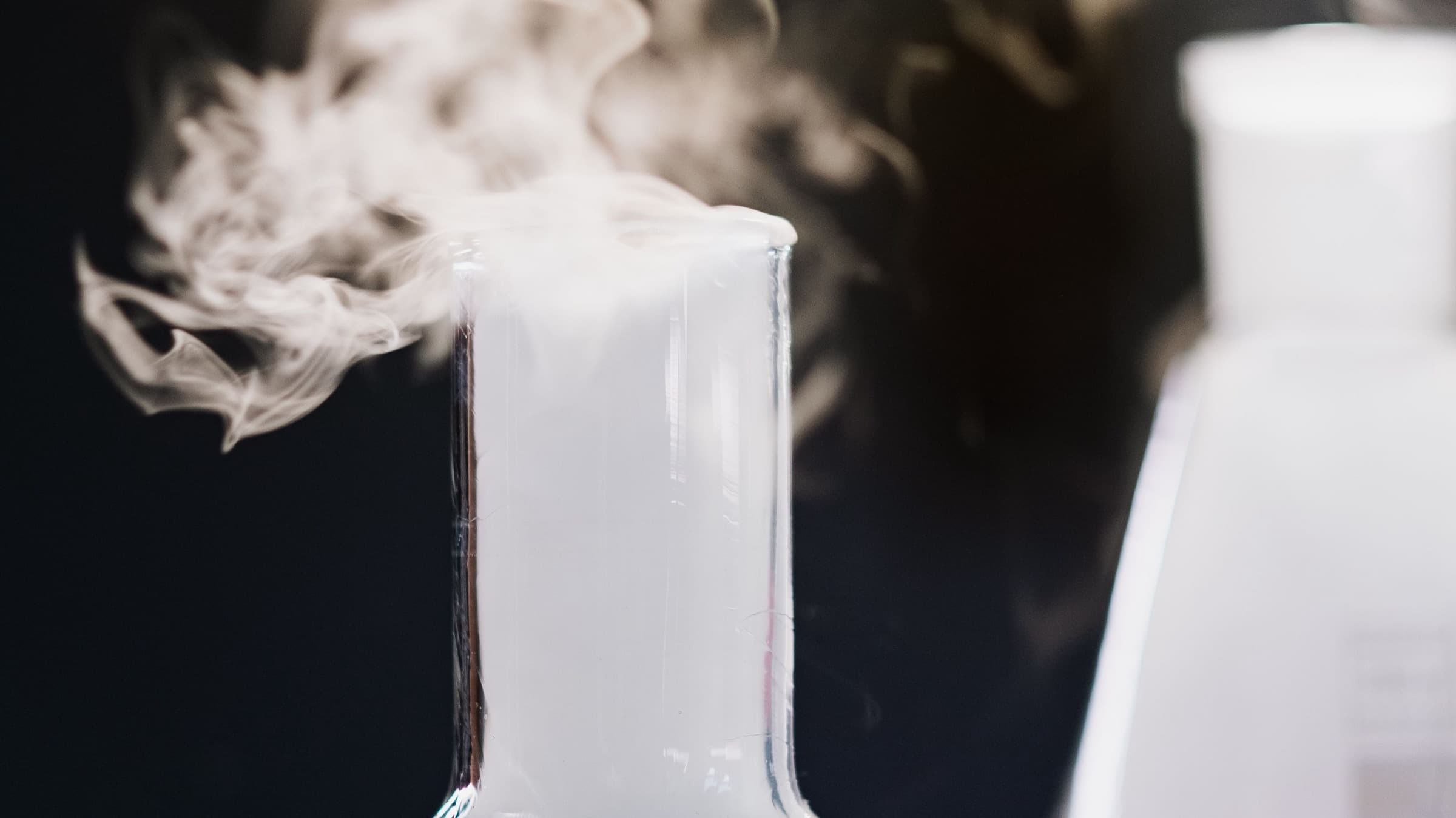 Vapour rising from laboratory flasks during a chemical reaction