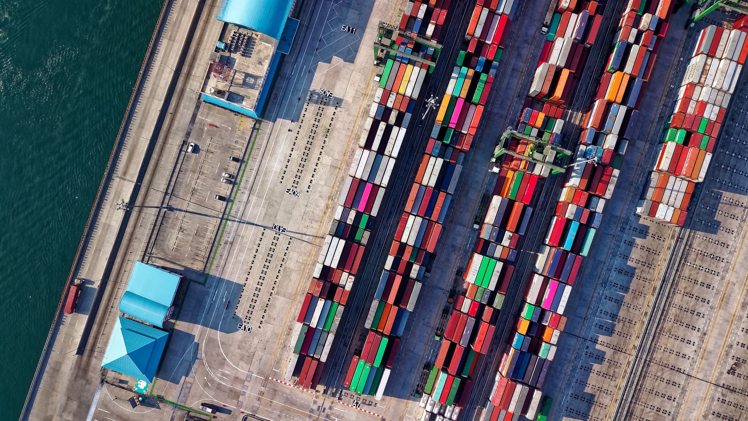 Aerial view of shipping containers and trucks at a port